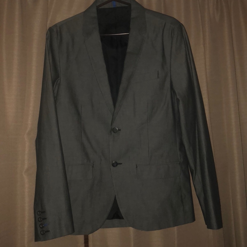 Young man Suit that is grey with stripes